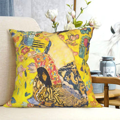 velvet polyester pillow cover with gold figure and floral decorative composition, shown on a cream sofa