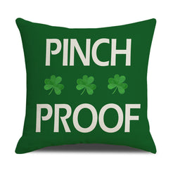 Short-pile plush pillow cover with Pinch Proof text and shamrocks on green, shown on white