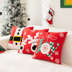 embroidered polyester canvas pillow covers with reindeer, JOY and snowflake embroidery, styled on a white sofa