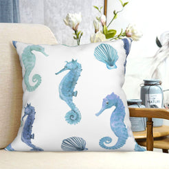 short-pile plush polyester pillow cover with blue and green seahorses and shells, shown on a cream sofa
