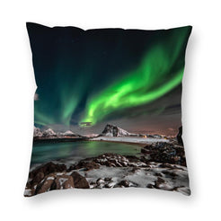 Custom photo pillow cover example printed with green northern lights over a rocky coast