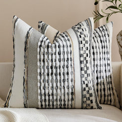 Set of two chenille-textured polyester pillow covers with black raised stripes and woven blocks on cream