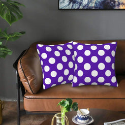 Purple polka dot velvet pillow covers styled on a sofa