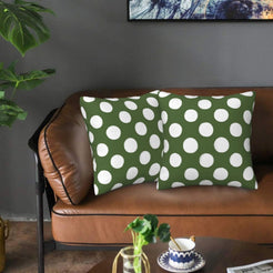 Olive green polka dot velvet pillow covers styled on a sofa