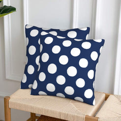 Navy blue polka dot velvet pillow covers styled on a woven chair