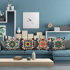 linen-look polyester pillow covers with colorful Mexican floral medallion prints, arranged on a blue sectional