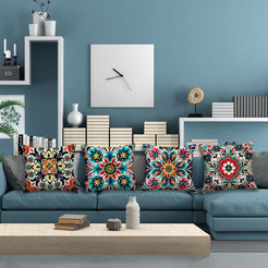 linen-look polyester pillow covers with red, teal and yellow floral medallion prints, arranged on a blue sectional
