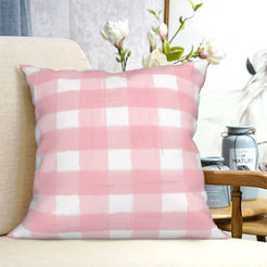 Pink buffalo plaid short-pile plush Easter pillow cover styled on a chair