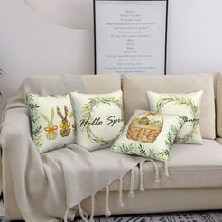 Cream Easter pillow covers with spring wreaths, bunnies and eggs, styled on a sofa