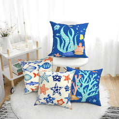 Short-pile plush polyester pillow covers with blue nautical fish and coral prints, arranged beside a white chair