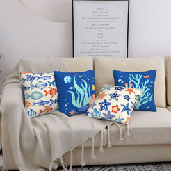 Short-pile plush polyester pillow covers with blue nautical sea life prints, styled on a cream sofa