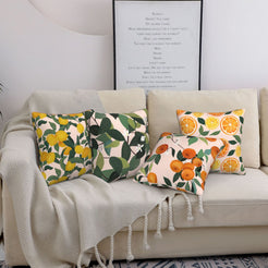 Summer short-pile plush pillow covers with citrus fruit and leafy patterns, styled on a sofa