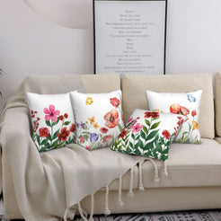 Short-pile plush pillow covers with watercolor wildflowers and butterflies, styled on a cream sofa