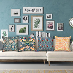 Short-pile plush polyester pillow covers with ornate blue, coral and cream floral prints, displayed on a white sectional