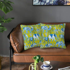 Velvet pillow covers with olive elephants, styled on a sofa