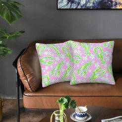 Velvet pillow covers with pink and green lobsters and shells, styled on a sofa