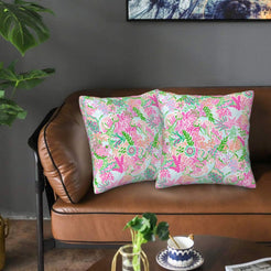 Velvet pillow covers with pink tropical coral and foliage, styled on a sofa