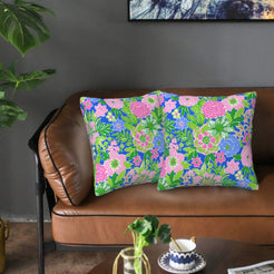 Velvet pillow covers with blue, pink and green mixed florals, styled on a sofa