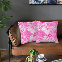 Velvet pillow covers with hot pink tonal flowers, styled on a sofa