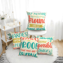 Four short-pile plush pillow covers with colorful motivational typography on a cream background, styled in a bright room
