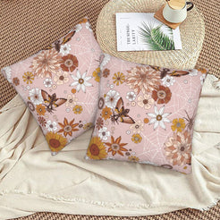 Halloween velvet pillow covers with blush spiderwebs and dahlias, styled on a woven chair