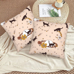 Halloween velvet pillow covers with blush black cats and celestial motifs, styled on a woven chair