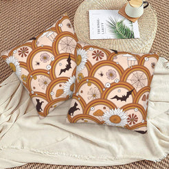 Halloween velvet pillow covers with blush retro arches, bats and daisies, styled on a woven chair