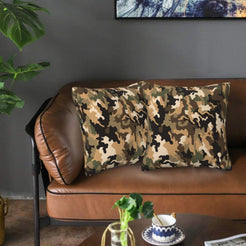 Velvet pillow covers with brown woodland camouflage, styled on a sofa