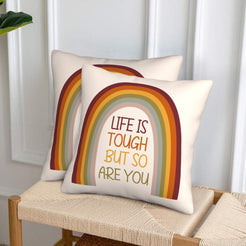 Velvet pillow covers with resilience rainbow quote, styled in a living room