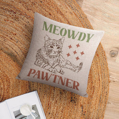 Linen-look pillow cover with Meowdy Pawtner cat illustration, styled on a chair