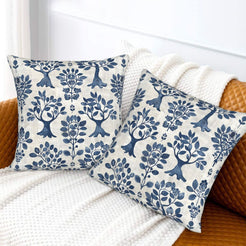 Block-print-inspired velvet pillow covers with navy folk trees and flowers, styled on a sofa