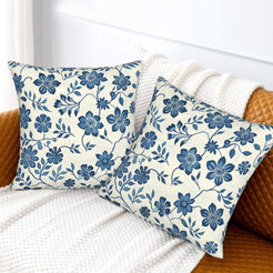 Block-print-inspired velvet pillow covers with blue daisy vines, styled on a sofa