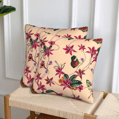Velvet pillow covers with burgundy flowers and butterflies on blush, styled on a woven chair