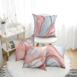 Four short-pile plush pillow covers with blush, blue and rose marble designs, styled in a bright room