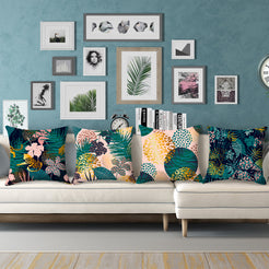 Short-pile plush pillow covers with dark tropical leaves and leopard spots, styled on a cream sectional