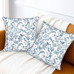 Toile floral velvet pillow covers with blue birds and wildflowers on white, styled on a sofa