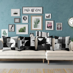 Short-pile plush pillow covers with black and gray Bauhaus-style geometry, styled on a cream sectional