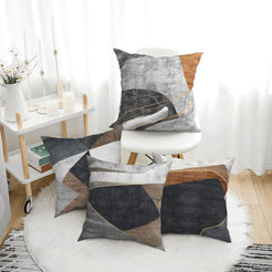 Short-pile plush pillow covers with gray, brown and black abstract geometry, styled in a bright room