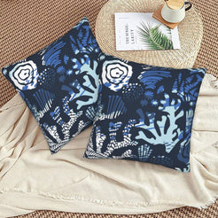 Coastal velvet pillow covers with midnight blue coral and flowers, styled on a floor cushion