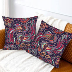 Velvet pillow covers with large magenta and teal paisley, styled on a white sofa