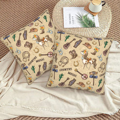 Western velvet pillow covers with cream country music motifs, styled on a woven chair