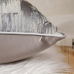 Side view of a silver gray jacquard pillow cover with hidden zipper