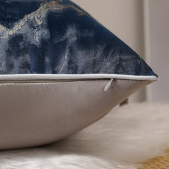 Side view of a navy jacquard pillow cover with hidden zipper