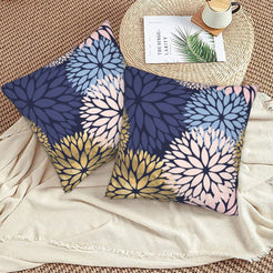 Navy, blush and gold dahlia pattern velvet pillow covers styled on a woven chair