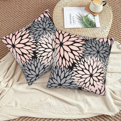 Black, blush and gray dahlia pattern velvet pillow covers styled on a woven chair