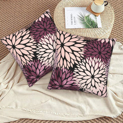 Black, blush and plum dahlia pattern velvet pillow covers styled on a woven chair