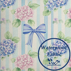Close-up of water-resistant linen-look polyester with hydrangeas and blue bows on pale stripes