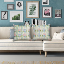 Water-resistant linen-look polyester pillow covers with hydrangeas and bows on green stripes, styled on a white sofa