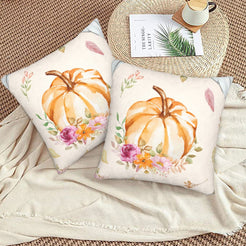Autumn velvet pillow covers with cream floral wreath pumpkin, styled on a woven chair