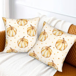 Autumn velvet pillow covers with cream repeating gold pumpkins, styled on a sofa